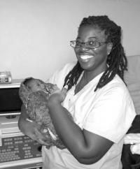 Marion Tinsley : Nurse from Mattpan holds a newborn she helped to deliver during a medical mission to Zambia last month.